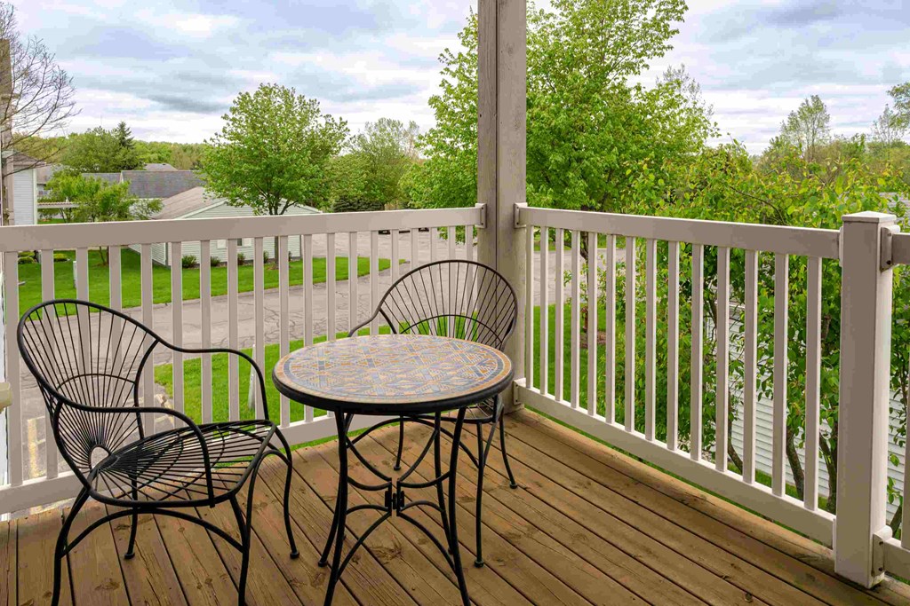 a patio with a table and chairs on a porch