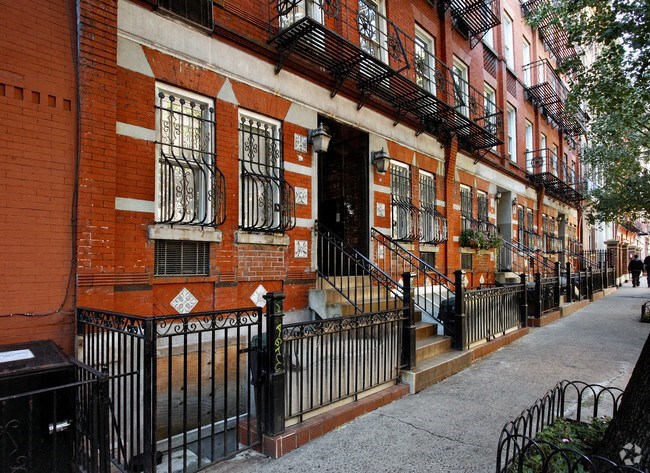 a red brick building with stairs in front of it