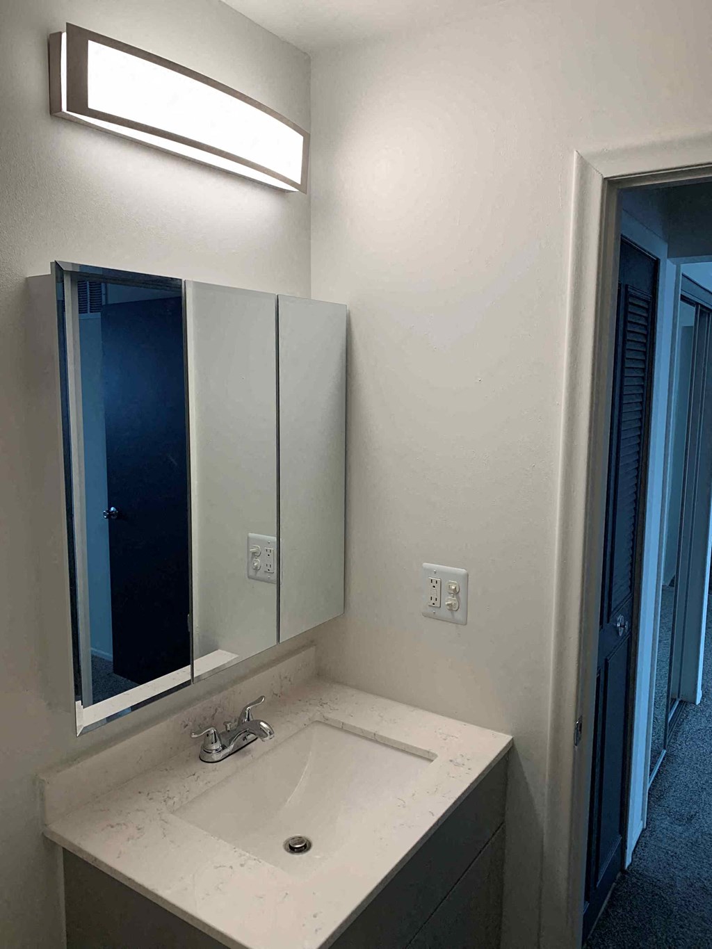 a small bathroom with a sink and a mirror