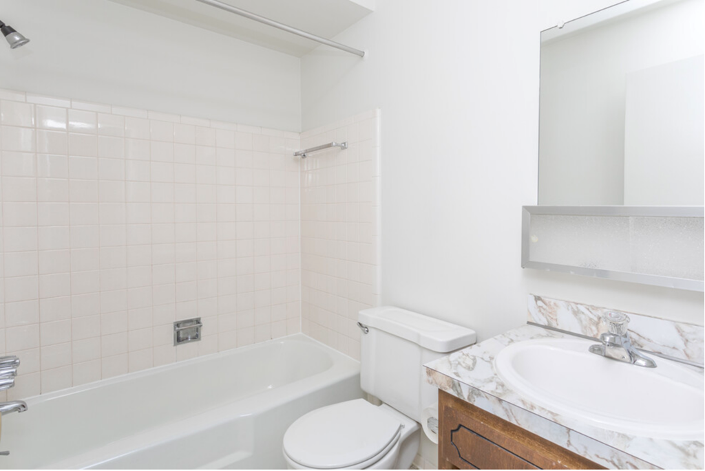 a bathroom with a sink toilet and bath tub