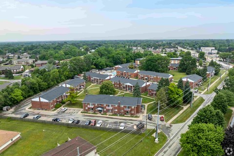 A large building complex with a parking lot in front.