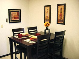 a dining room with a table and chairs