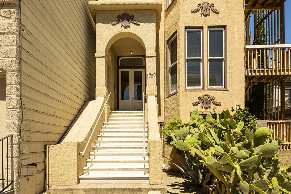 A house with a staircase leading to the front door.