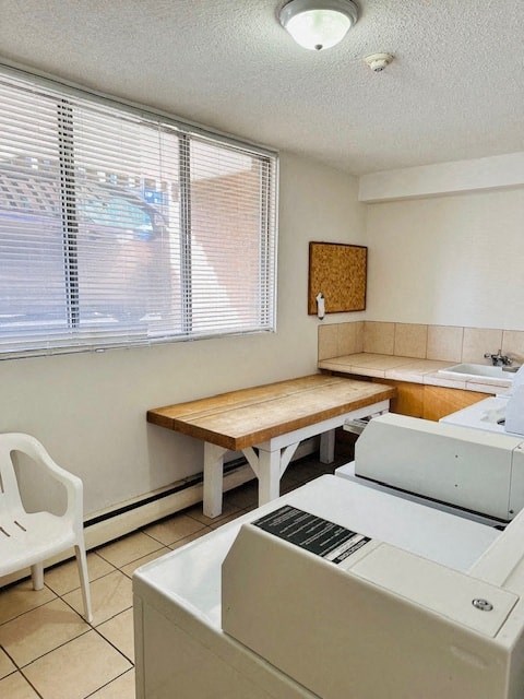 a kitchen with a table and a refrigerator and a sink