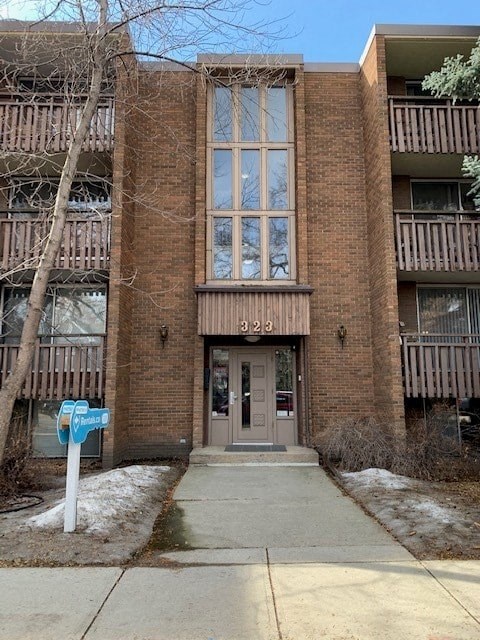 a brick building with a sidewalk in front of it