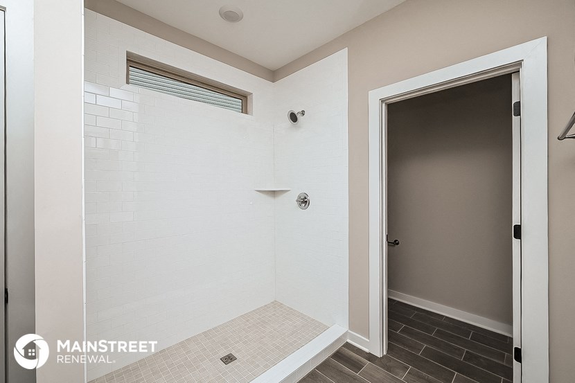 the master bathroom has a large shower and a door to the closet