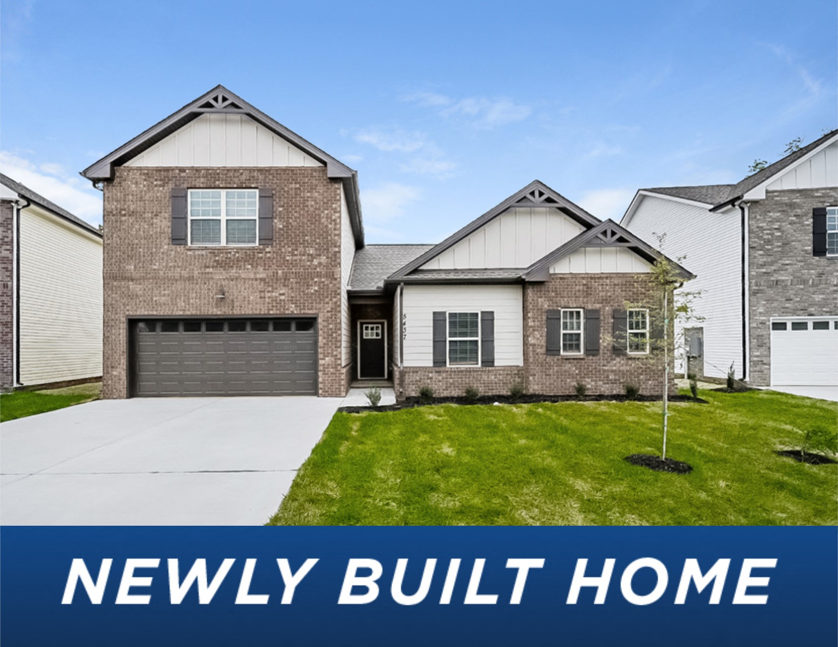 a new build home in front of a green lawn and