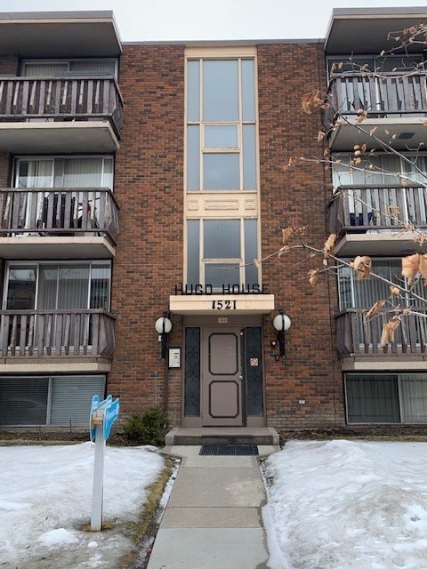 a brick apartment building with snow in front of it