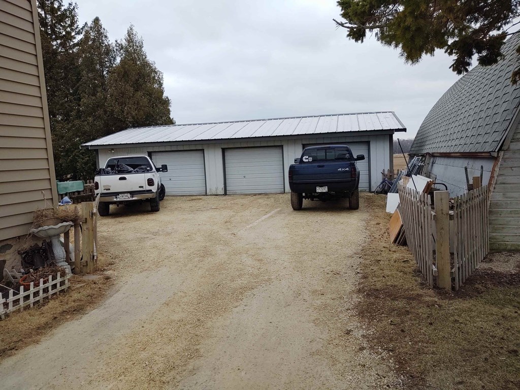 a garage with two trucks parked in front of it