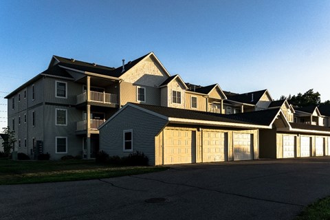a large house with a garage with a clear blue sky