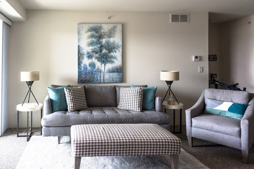 a living room with a couch and two chairs