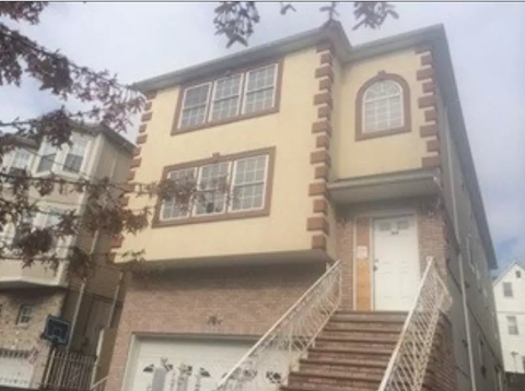 the front of a house with a staircase in front of it