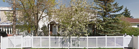 a white fence in front of a house
