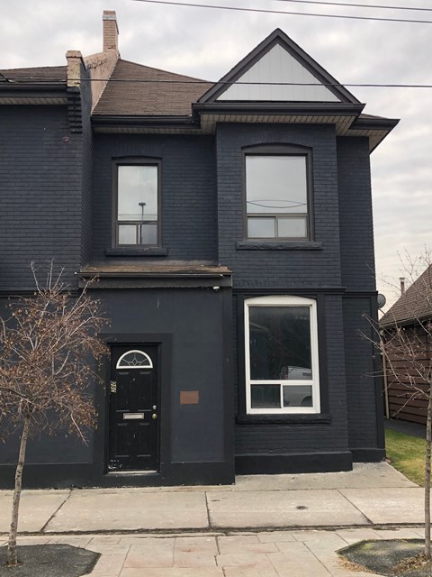 a black house with a black door and window