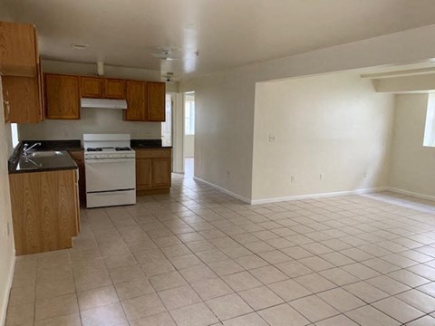 A kitchen with white appliances and wooden cabinets.