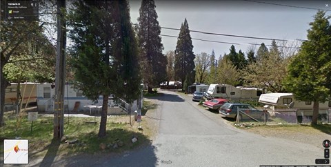 the street is full of rvs and cars parked on the side of the road