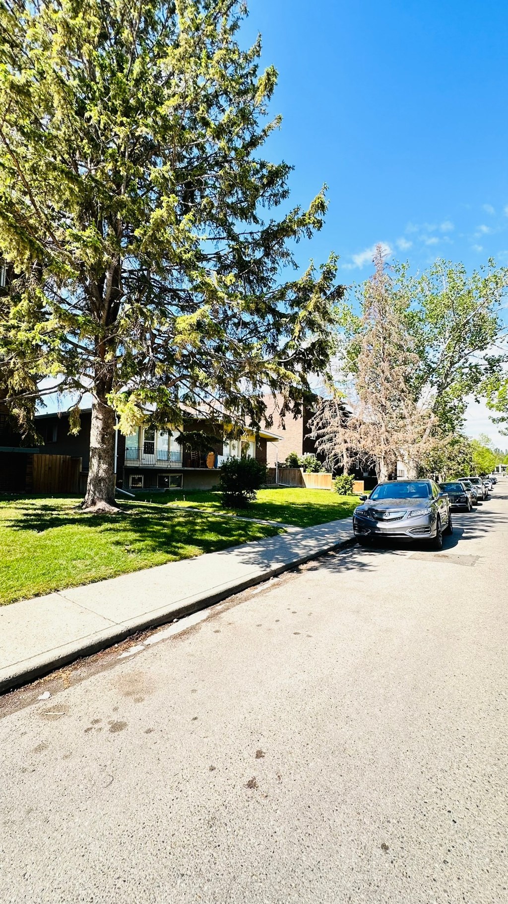 a street with a car parked on the side of the road