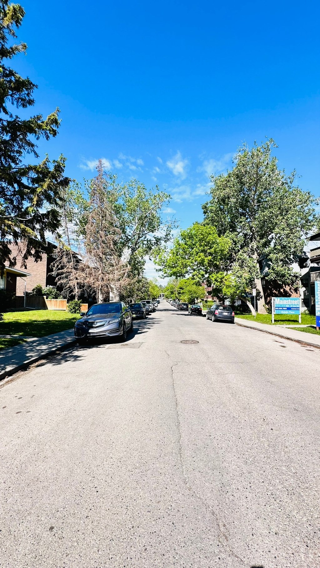 a street with cars parked on the side of it