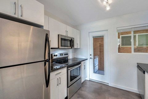 a kitchen with stainless steel appliances and white cabinets