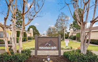 the entrance to mountain gate apartments in mountain gate az with trees