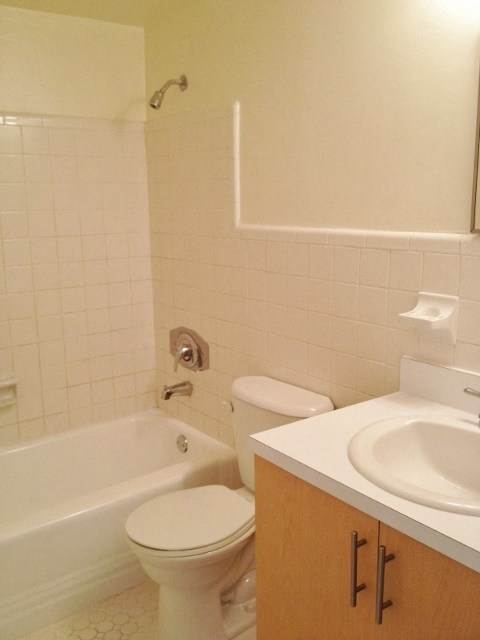 a bathroom with a toilet and a sink and a bath tub