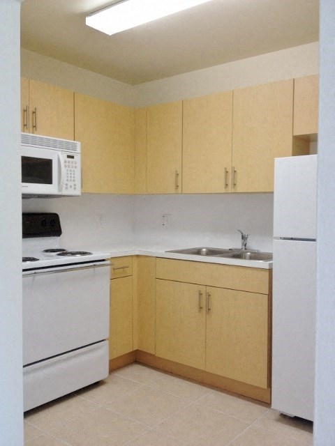 a kitchen with a stove microwave and a sink