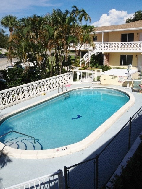 a large swimming pool in front of a house