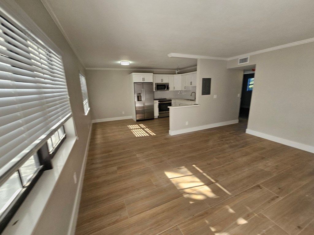 a view of the living room and kitchen of a new home