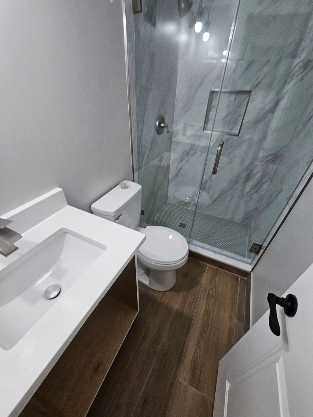 a bathroom with a sink toilet and a shower