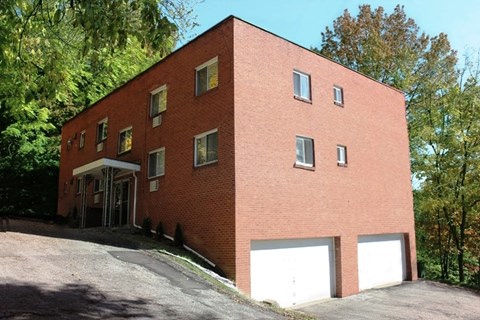 A red brick building with a white garage door.