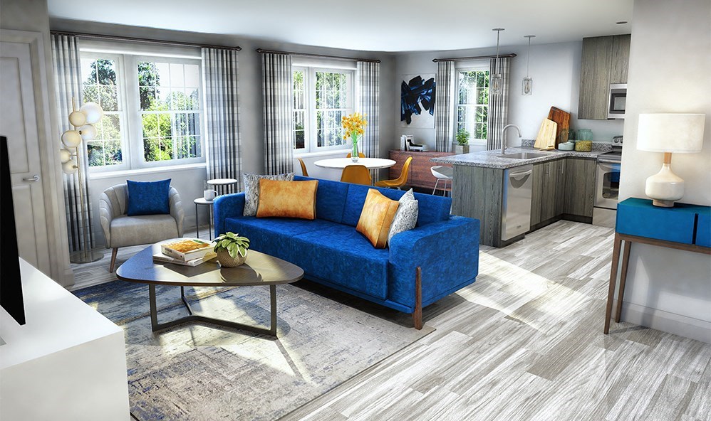 a living room with a blue couch and a kitchen