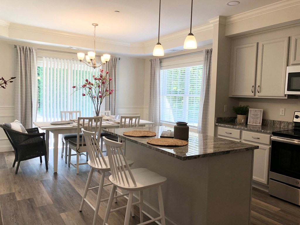 a kitchen with an island and a table with chairs