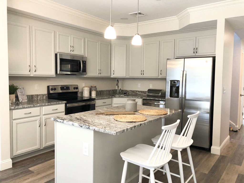 a kitchen with white cabinets and a counter top
