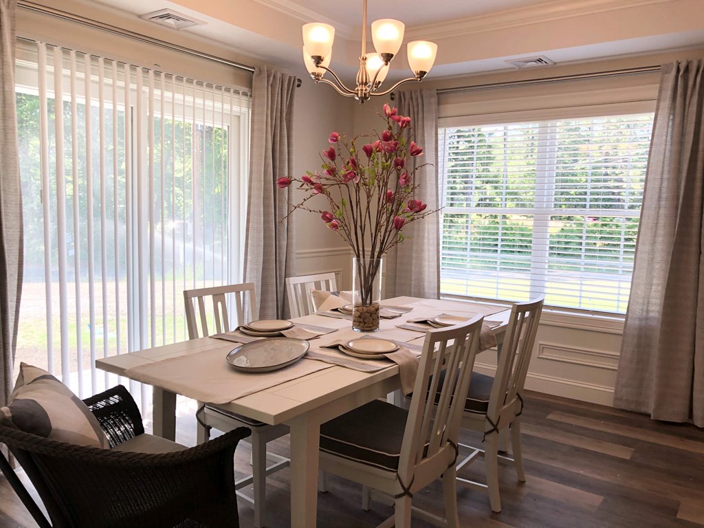 a dining room with a table and chairs