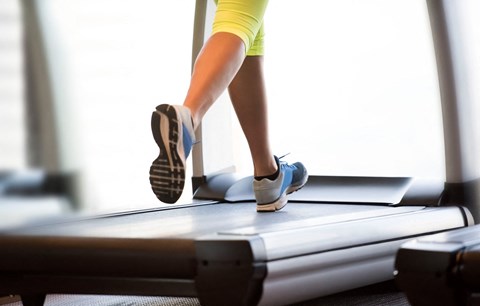 a woman running on a treadmill in the gym