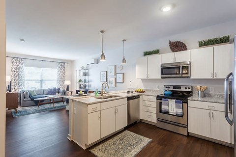 a kitchen with an island and a stove and a sink