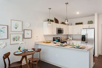 a kitchen and dining area with a counter top