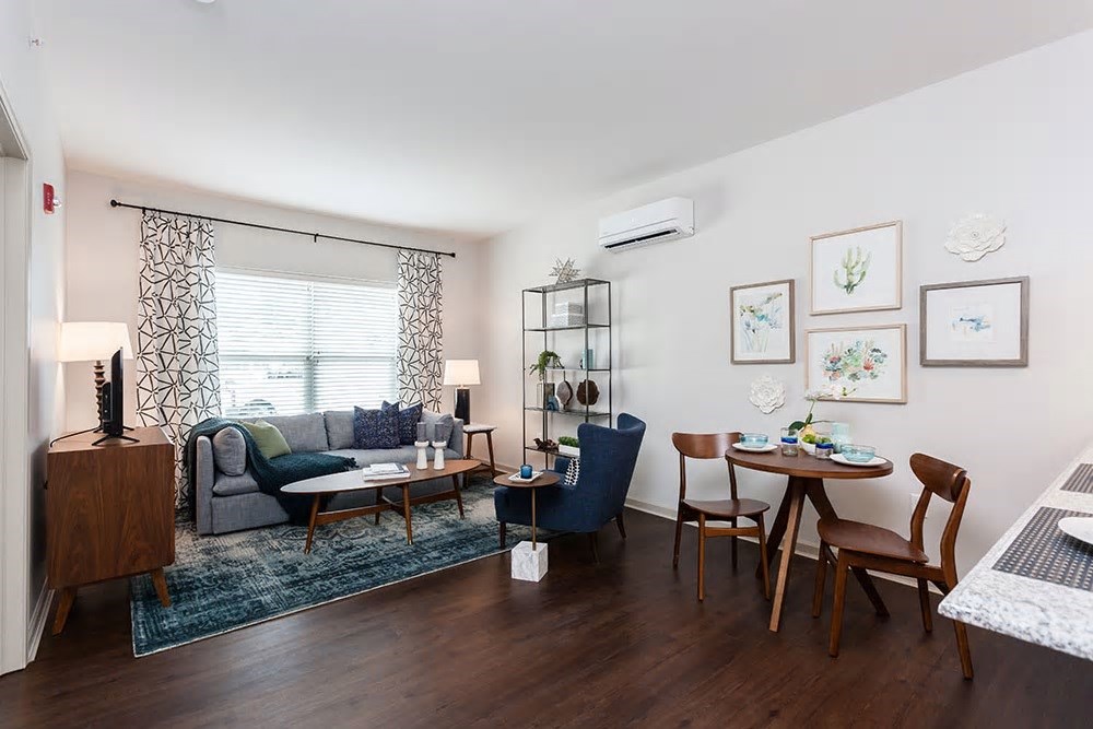 a living room with a couch and a dining room table