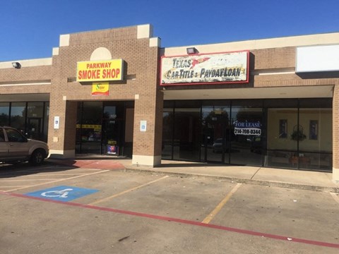 A car dealership with a Texas Car Title & Payday Loan advertisement.