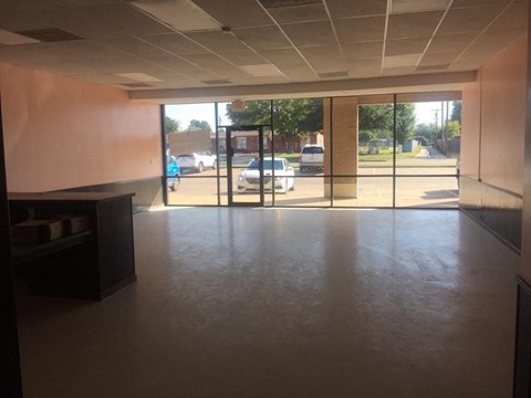 A view of a parking lot from a building entrance.