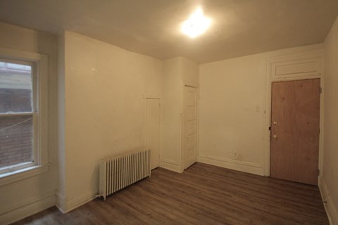 the living room of an empty house with a wood floor