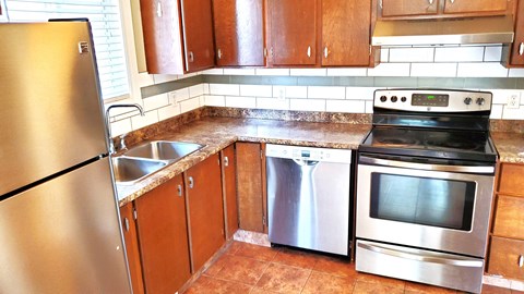 a kitchen with stainless steel appliances and wooden cabinets
