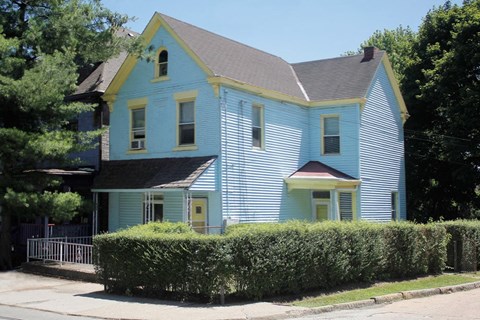 A blue house with a yellow trim.