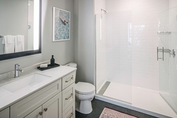 Quarter baths feature a glass shower enclosure and subway tile - Photo Gallery 5