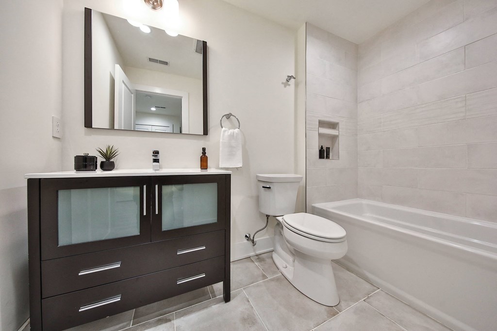 a bathroom with a toilet and a sink and a bath tub