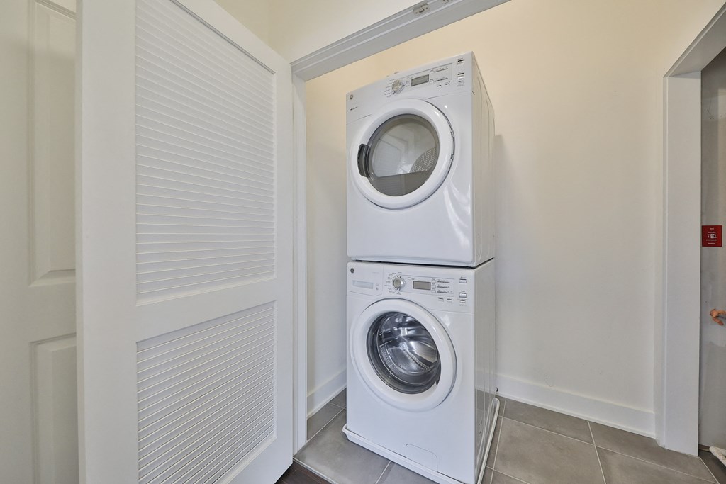 a front loading washer and dryer in a laundry room