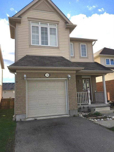 a yellow house with a white garage door
