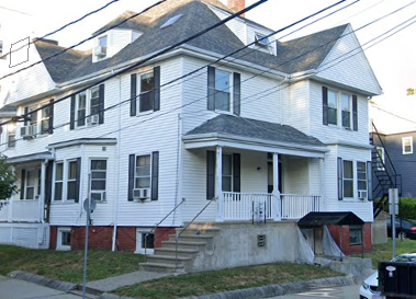 a white house on the corner of a street