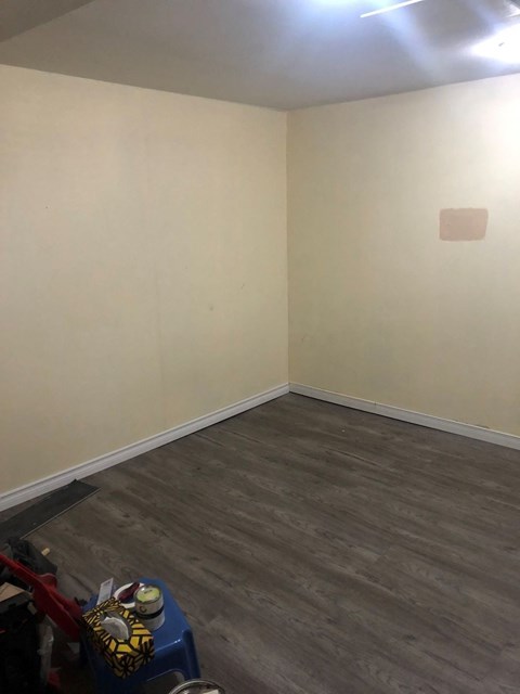 a room with white walls and a wood floor