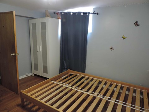 a bedroom with a bed and a closet and a curtain